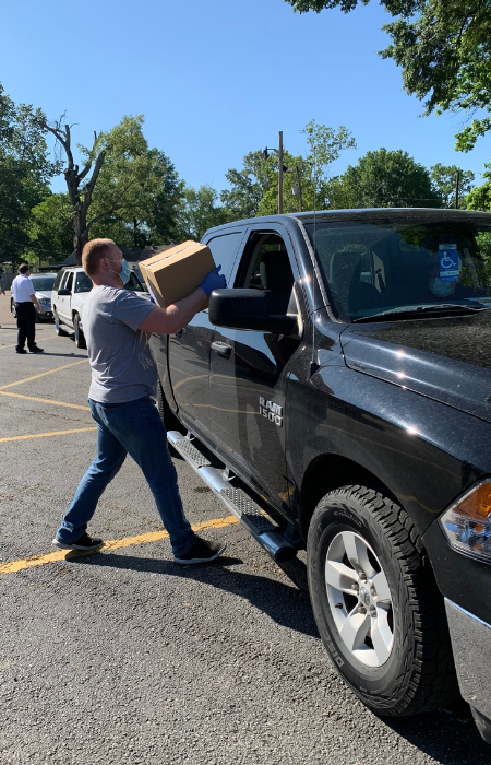 Man loading food box into truck