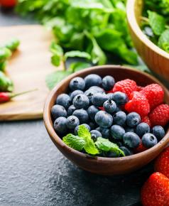 fresh blueberries and raspberries in bowl on table 